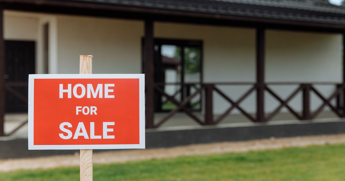 Home for Sale sign in front of a house